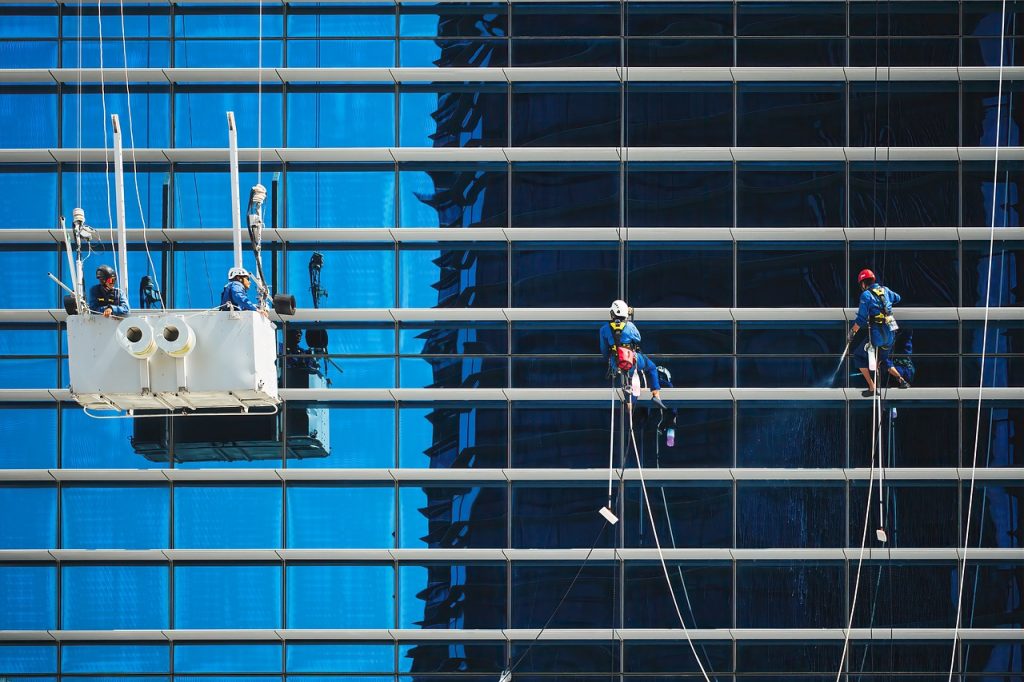 Workers cleaning the building windows